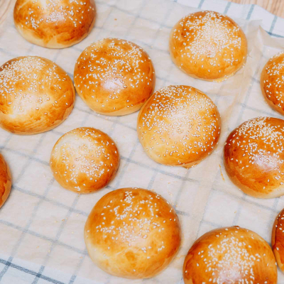 Bułki do burgerów – złociste, domowe bułki ułożone na blaszce, idealne do przygotowania burgerów